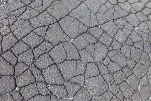 asphalt cracked like alligator skin